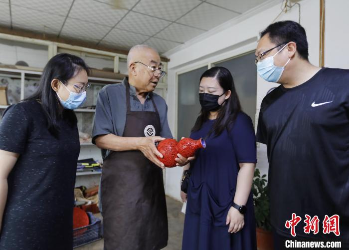 在河北省固安縣南宋村，雕漆匠人朱慶元向來賓介紹漆器作品?！￠T叢碩 攝